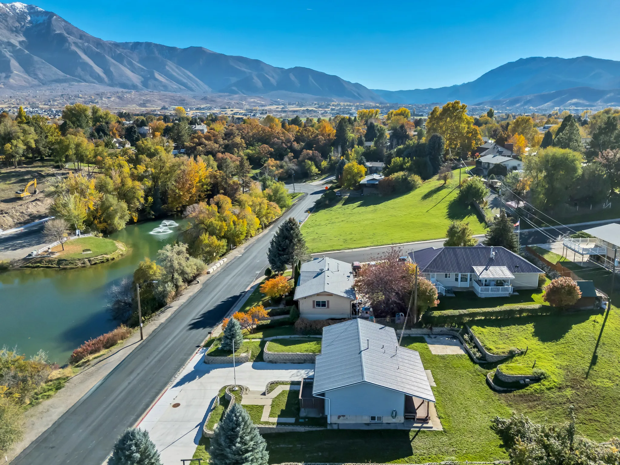 Aerial perspective of suburban area with a water and mountain view