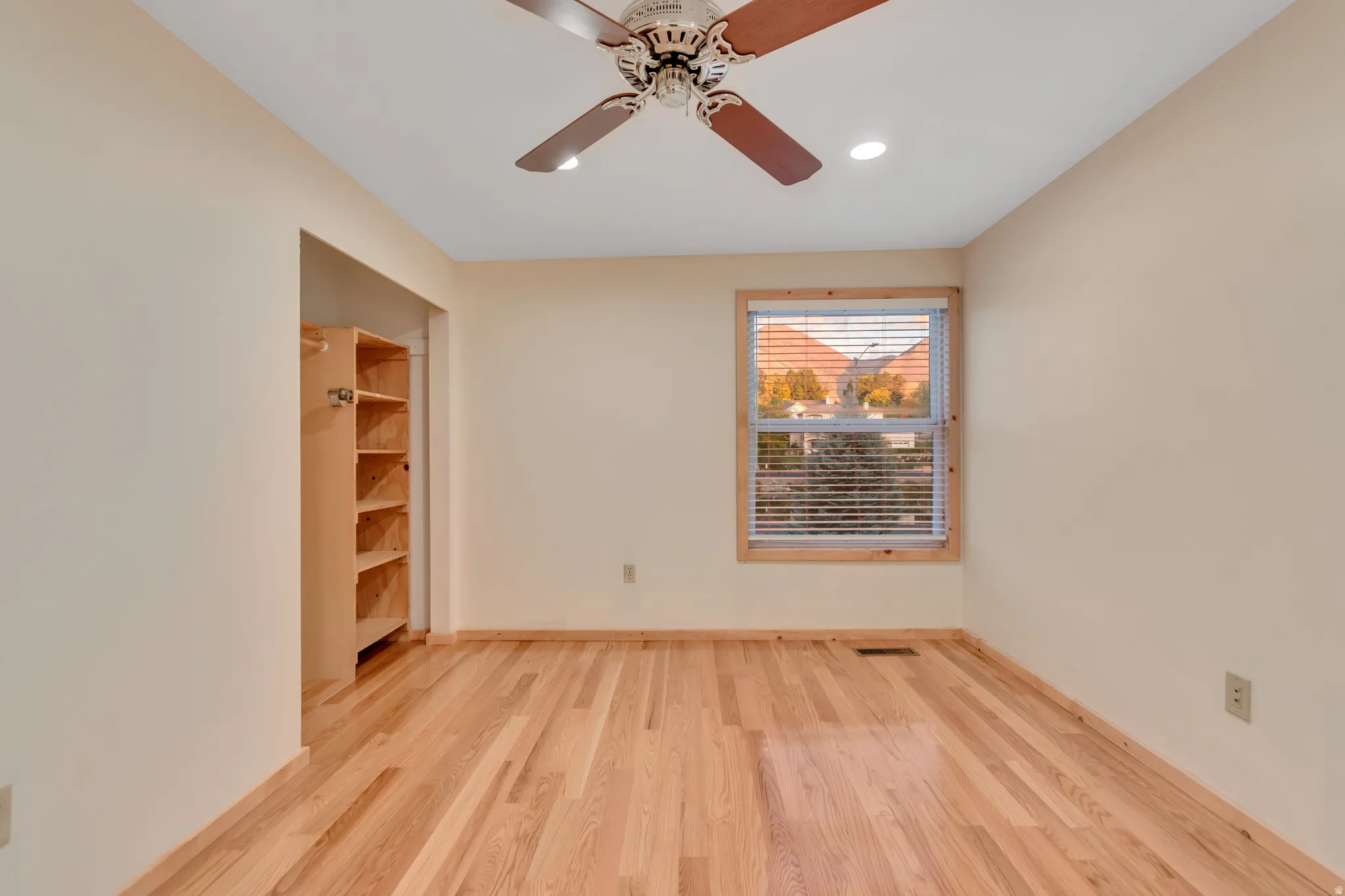 Empty room with light wood-style floors, a ceiling fan, and recessed lighting