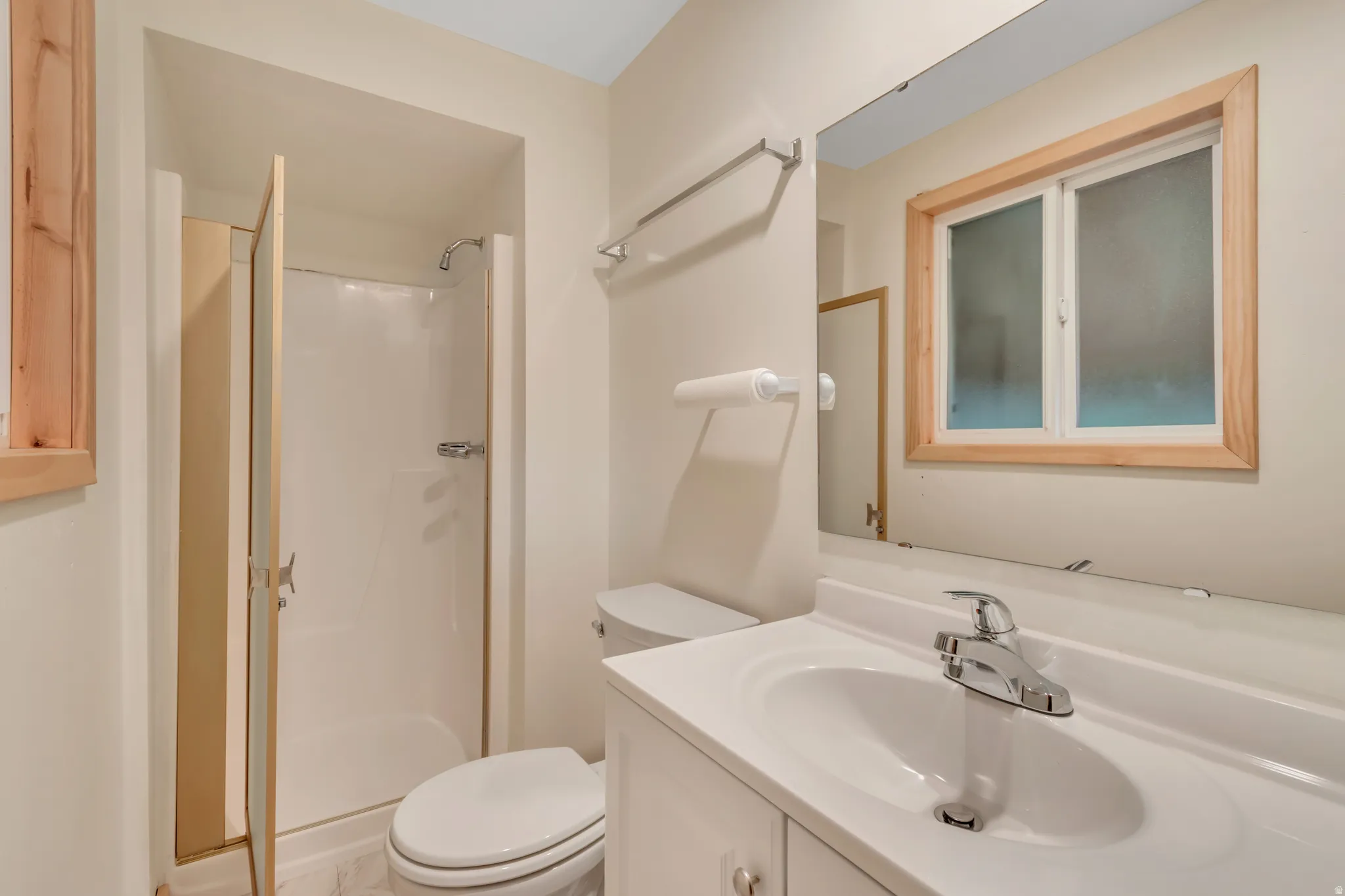 Bathroom with a shower stall and vanity