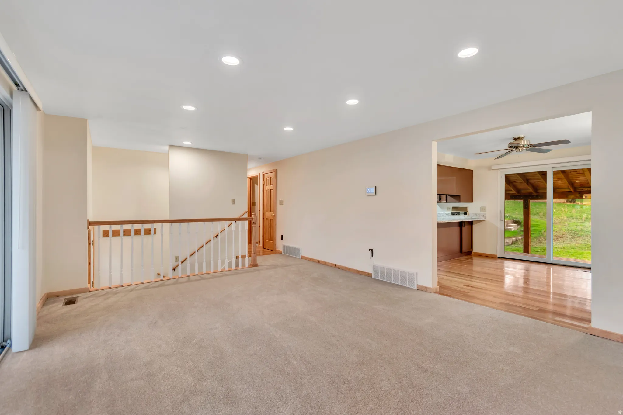 Spare room with recessed lighting, light carpet, and a ceiling fan