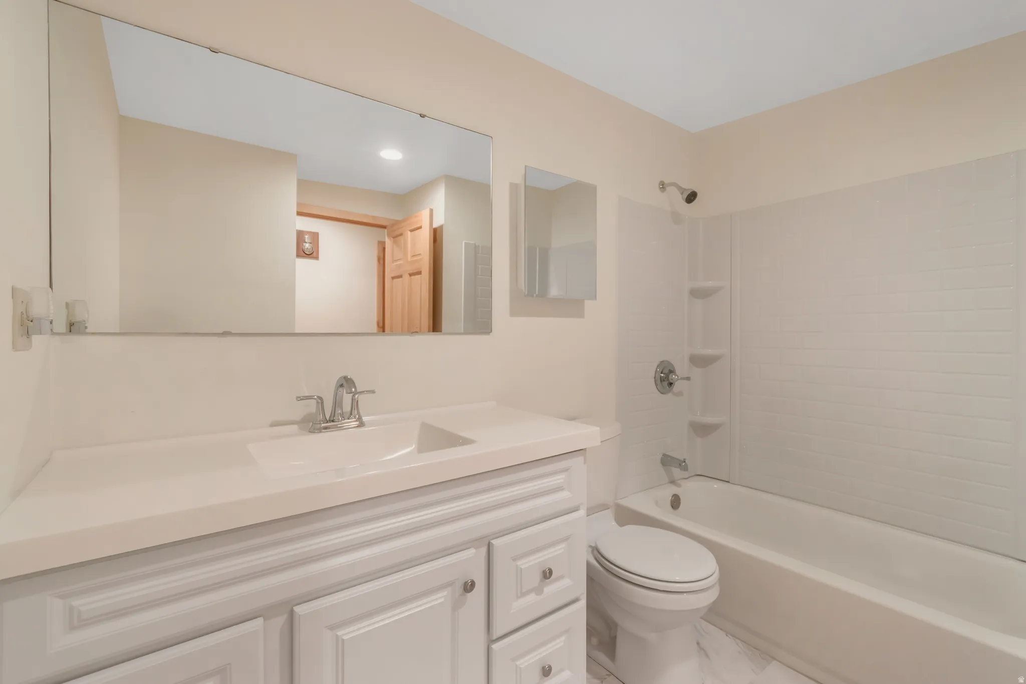 Full bath featuring vanity and shower / bathtub combination