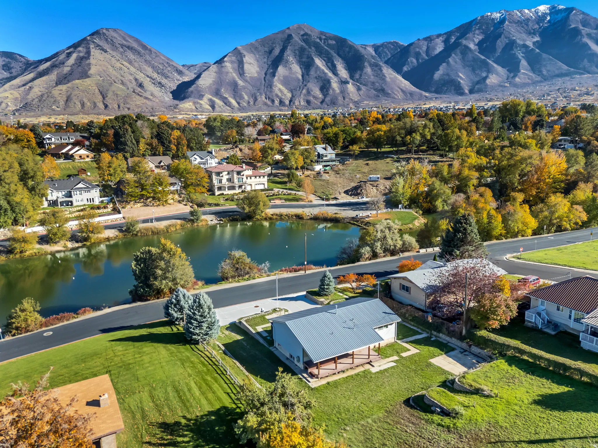 Aerial perspective of suburban area with a water and mountain view