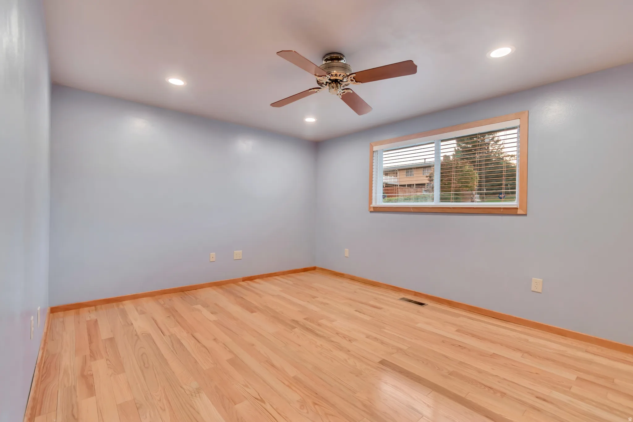 Spare room with light wood finished floors, recessed lighting, and a ceiling fan