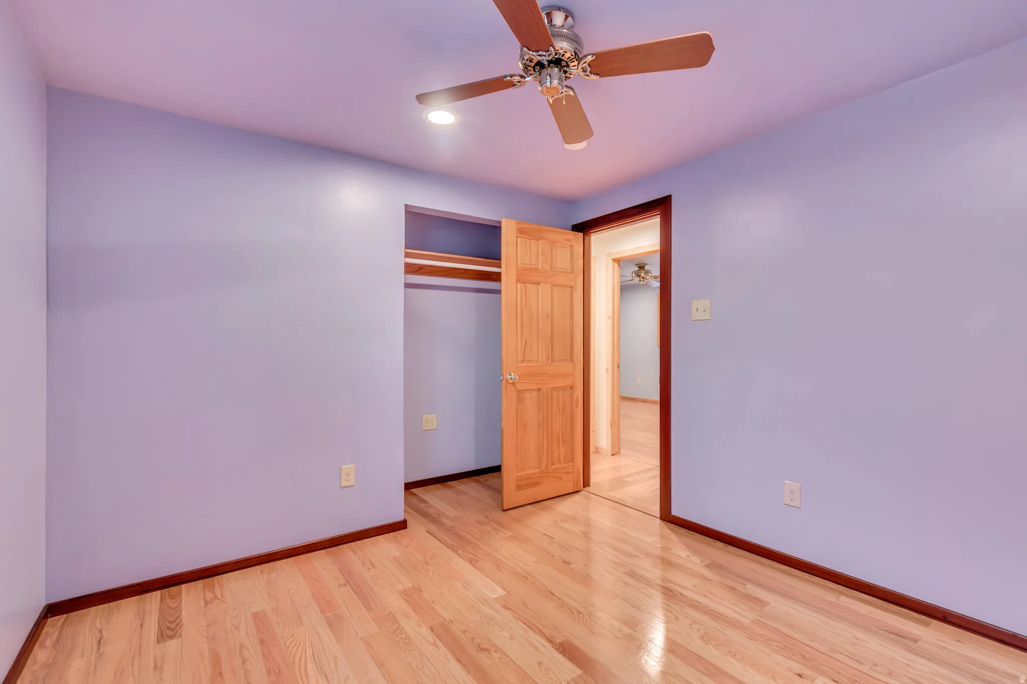 Unfurnished bedroom with light wood-style floors, a ceiling fan, a closet, and recessed lighting