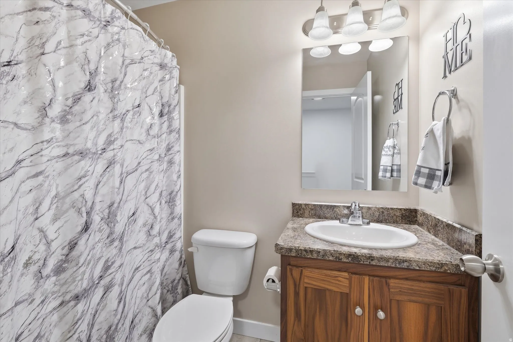 Full bath with vanity and a shower with curtain