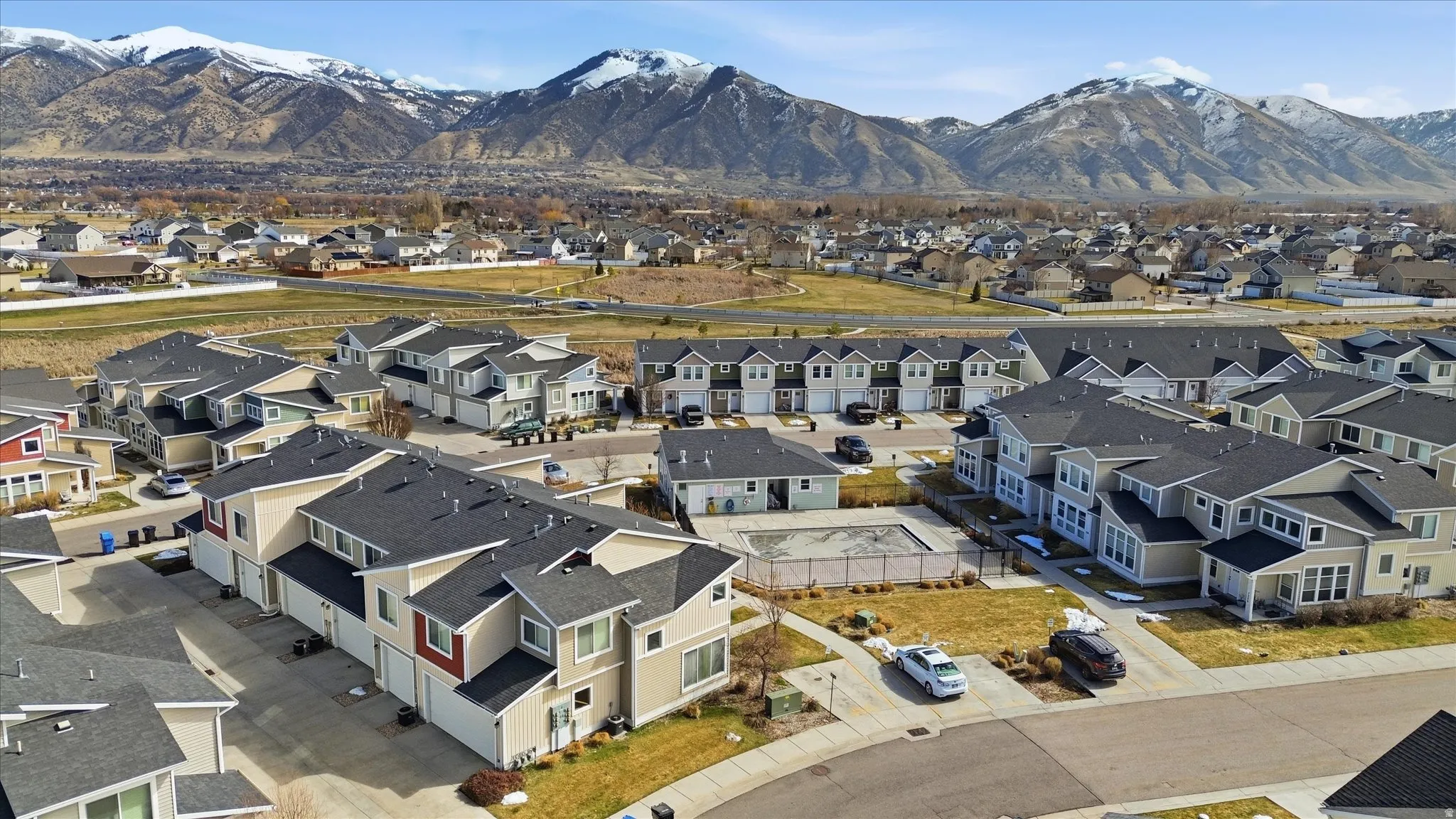 Aerial perspective of suburban area featuring a mountainous background