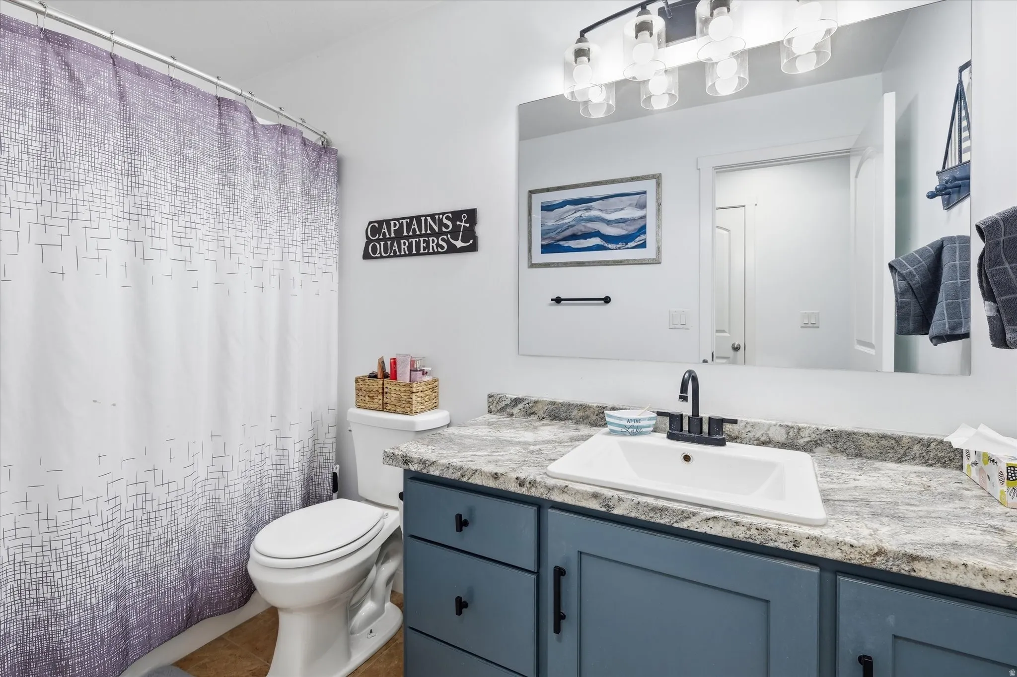 Bathroom featuring vanity and curtained shower