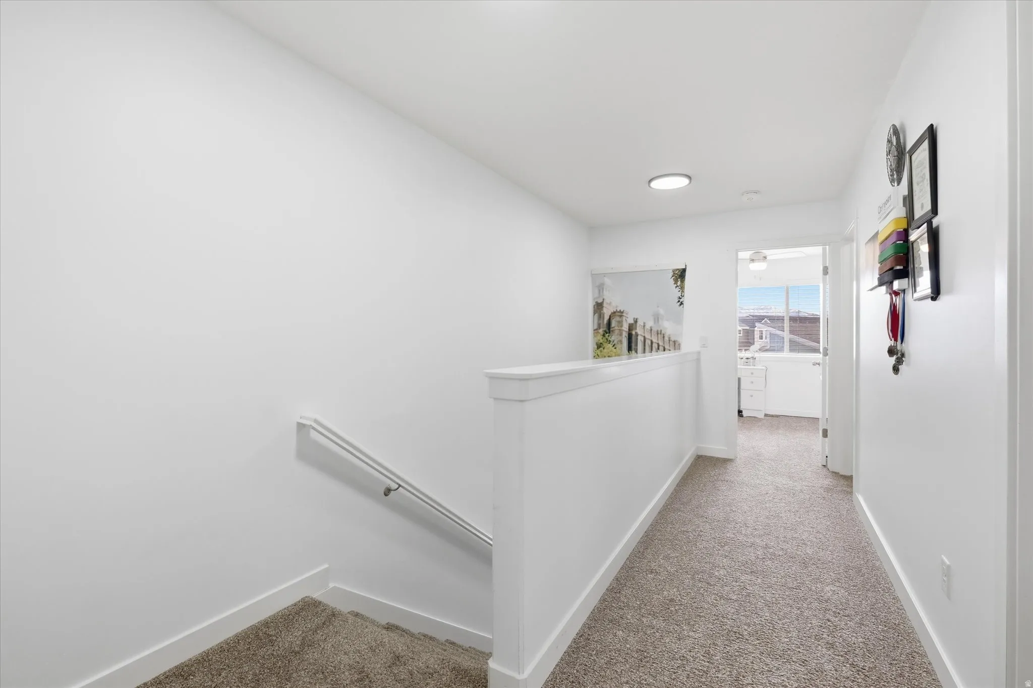 Hall with an upstairs landing and light carpet