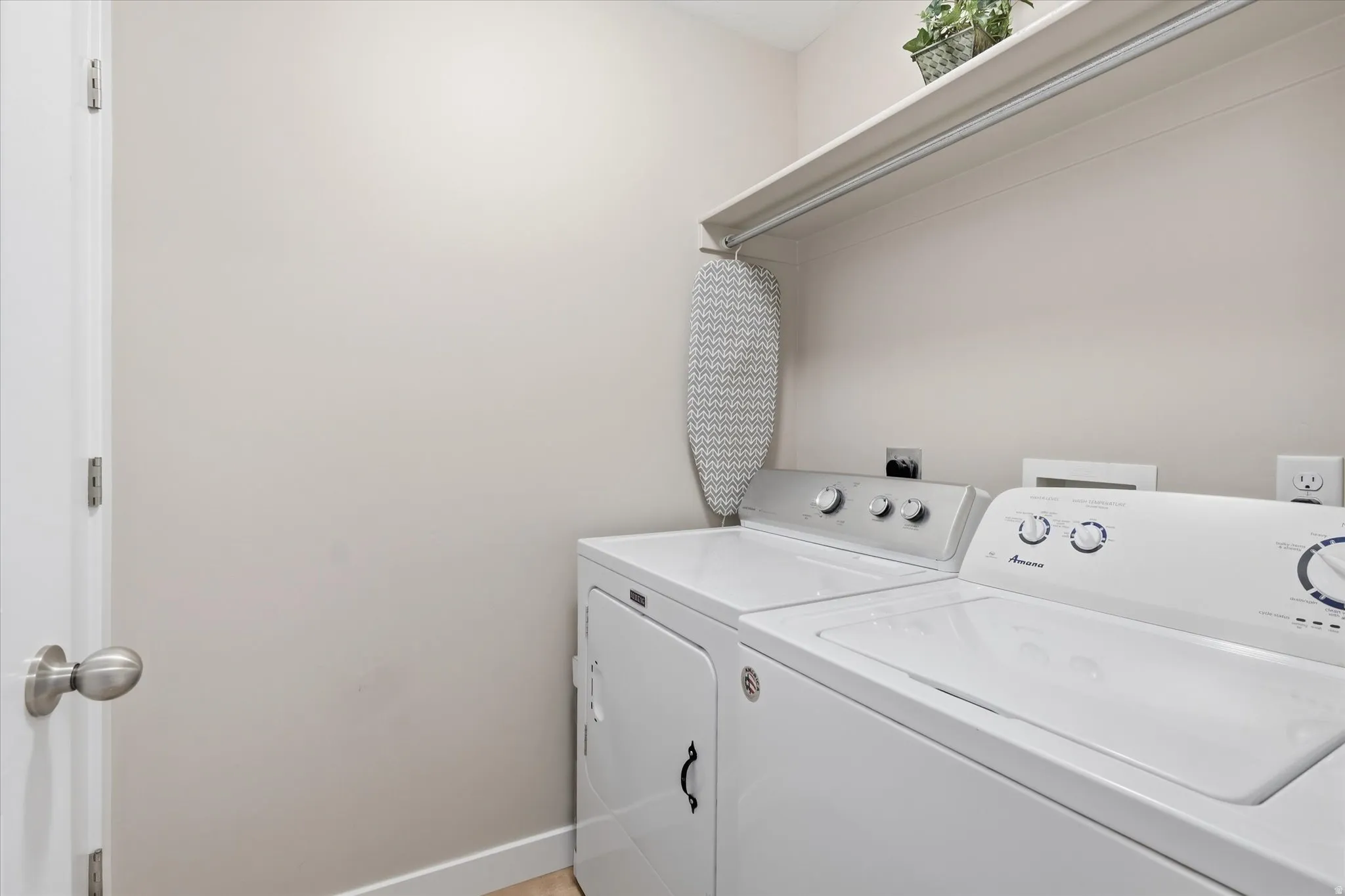 Laundry room featuring baseboards and washing machine and dryer