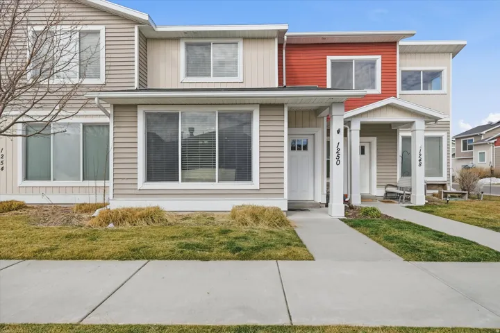 Traditional home with a porch, a front yard, and board and batten siding