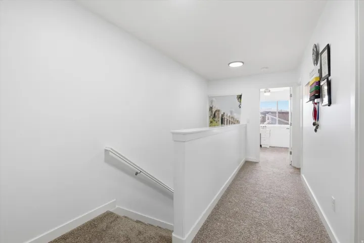 Hall with an upstairs landing and light carpet