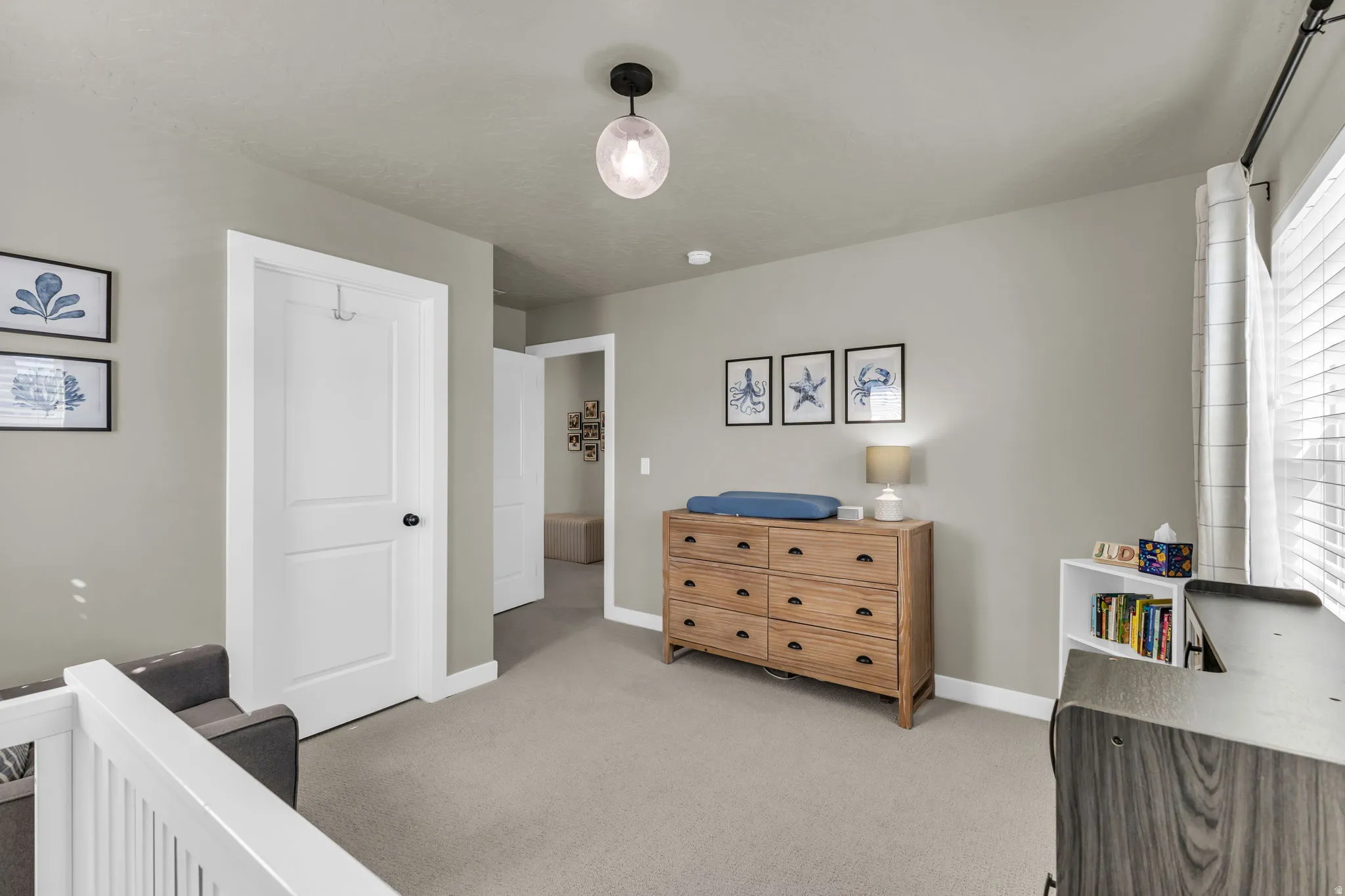 Bedroom with baseboards and light carpet
