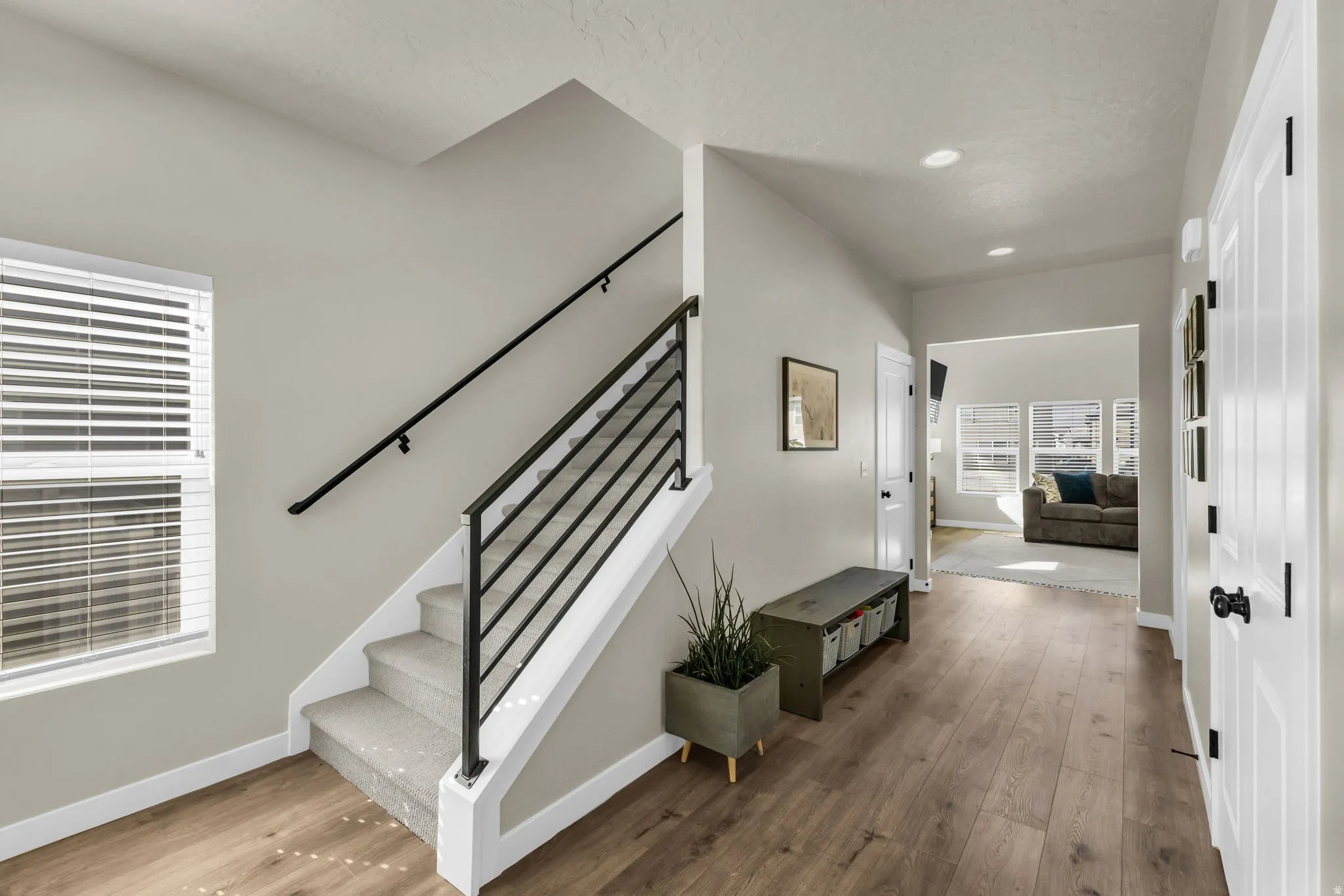 Staircase featuring wood-type flooring and recessed lighting