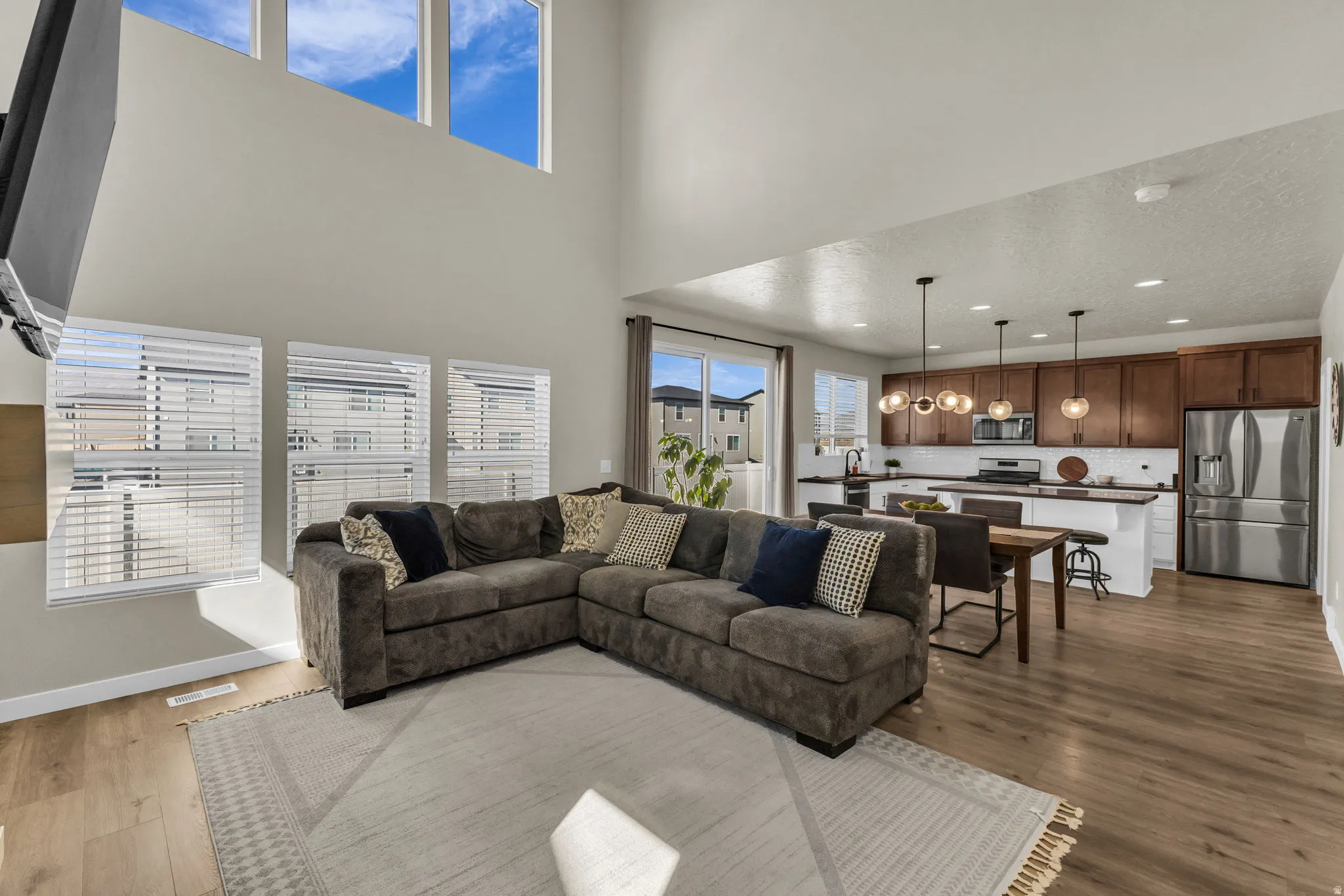 Living area with dark wood-style flooring and recessed lighting