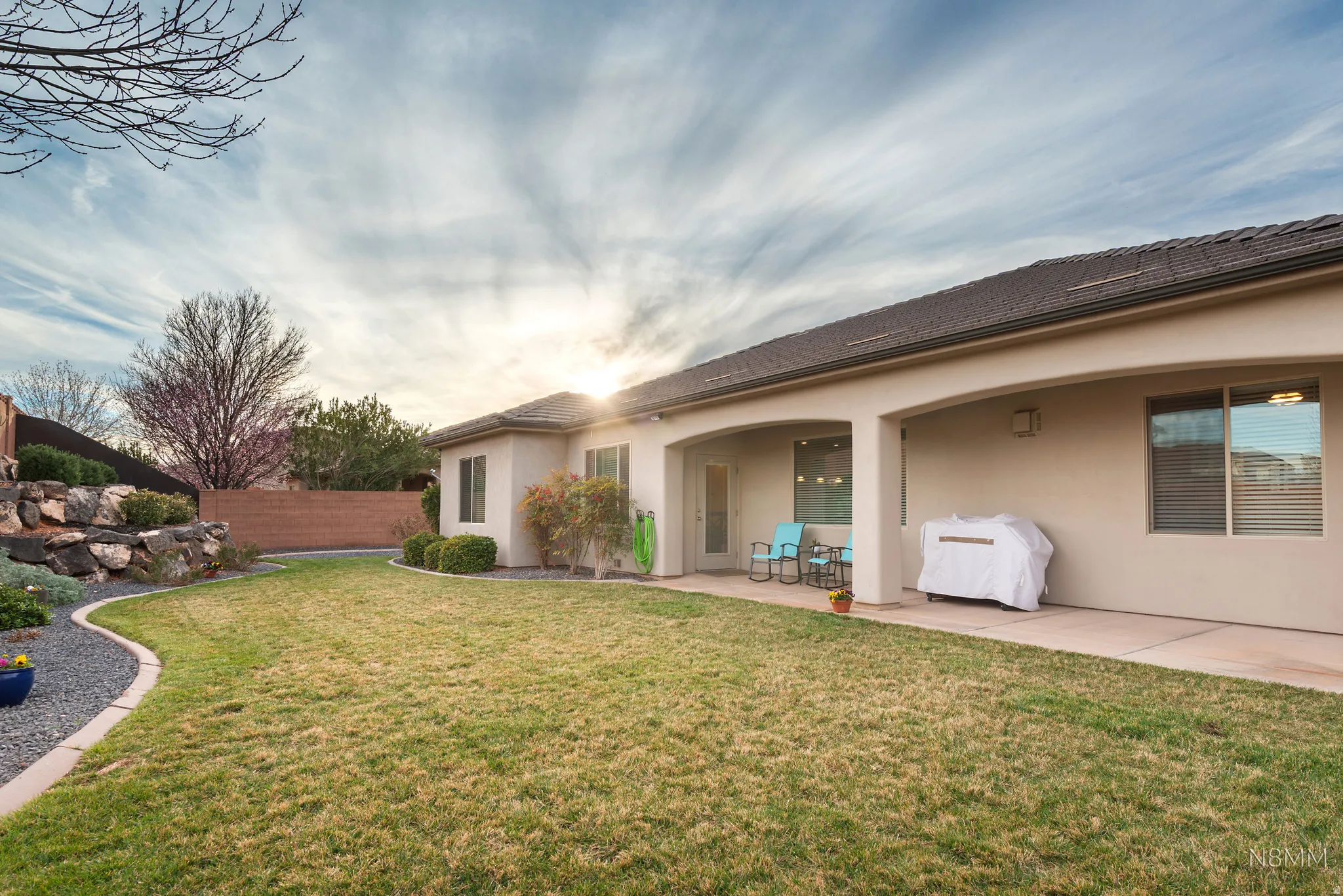 Back of house with stucco siding and a patio area