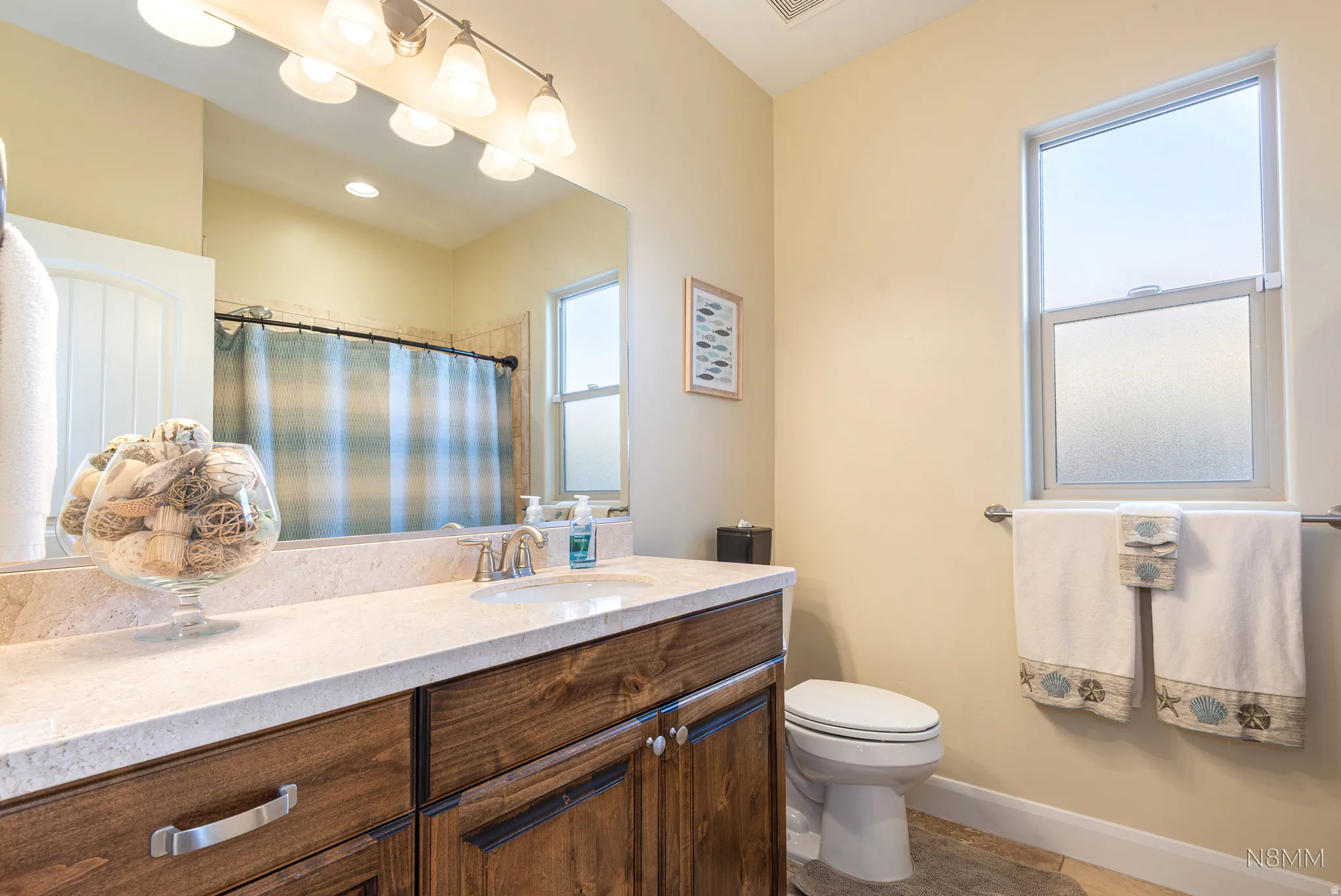 Bathroom with vanity, curtained shower, and light tile patterned floors