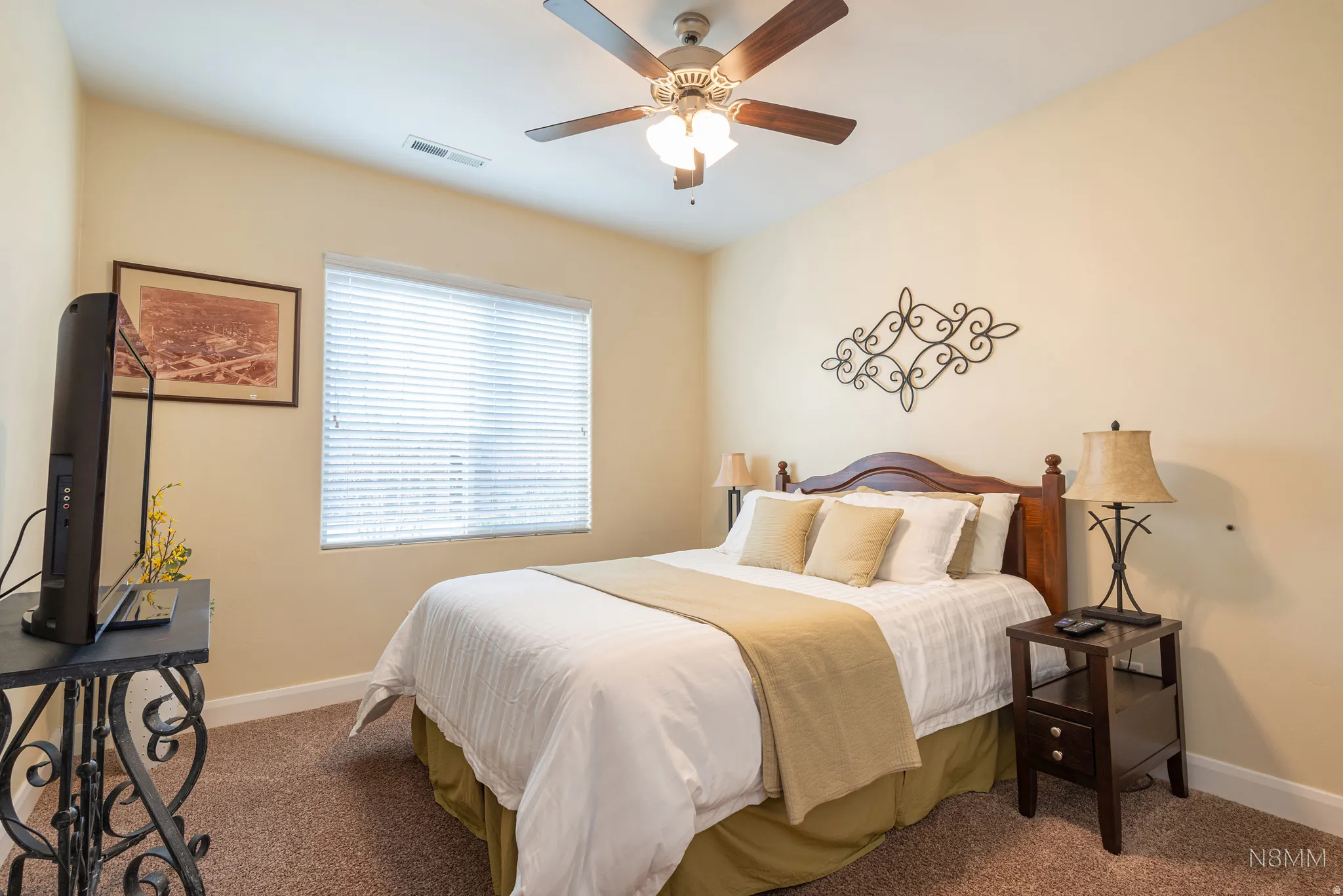 Bedroom featuring a ceiling fan and dark colored carpet