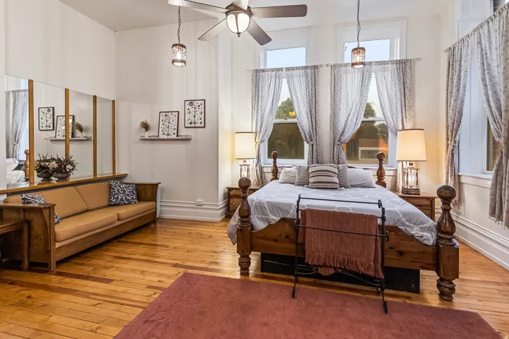 Bedroom with wood-type flooring and ceiling fan
