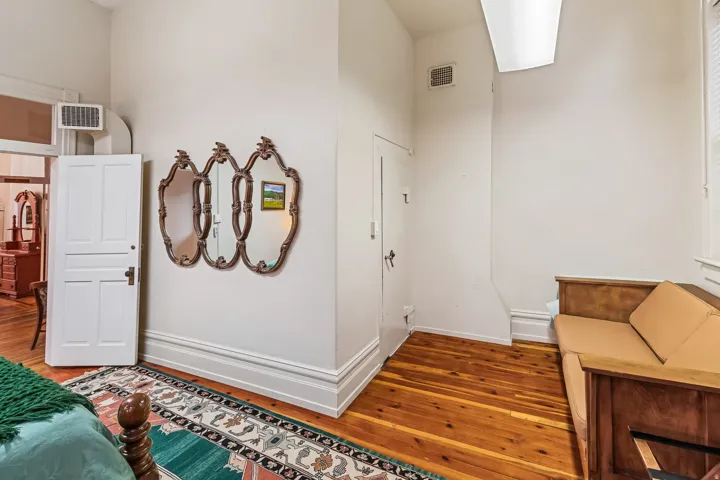 Bedroom with hardwood / wood-style floors and baseboards