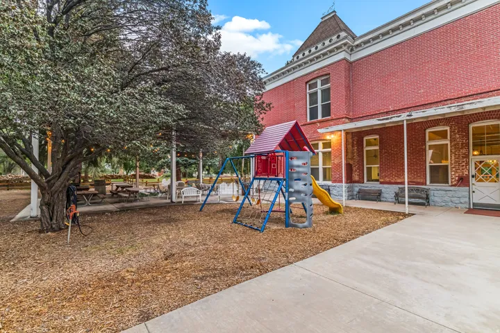 Community playground featuring a patio area