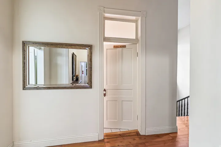 Hallway with baseboards and light wood finished floors