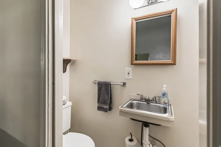 Half bath featuring toilet and a sink