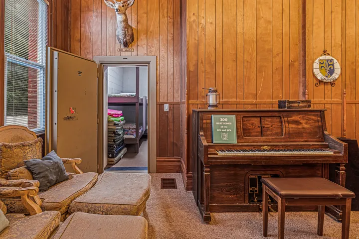 Sitting room featuring wooden walls and carpet