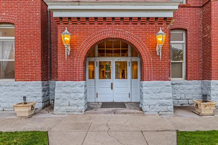 Entrance to property featuring brick siding and french doors