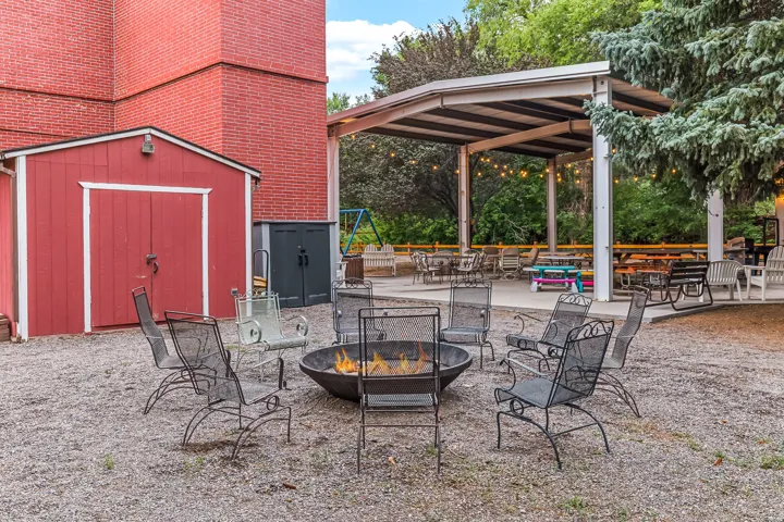 View of patio featuring a storage shed and a fire pit