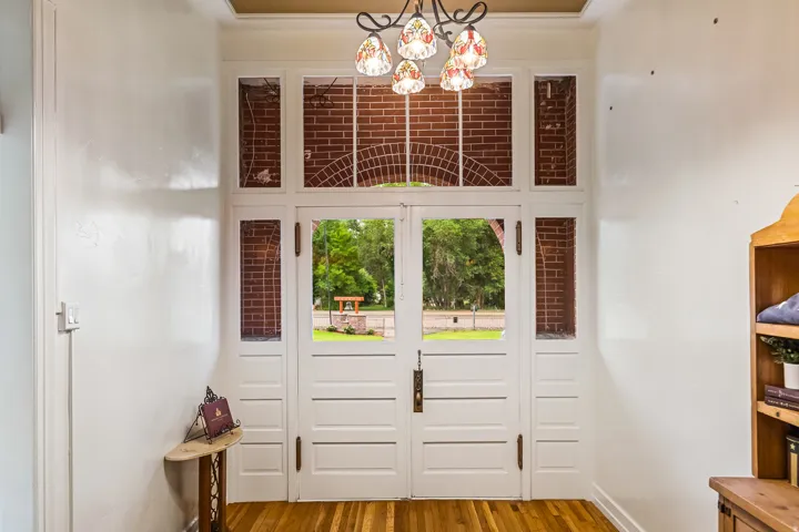 Foyer with a chandelier and dark wood-style flooring