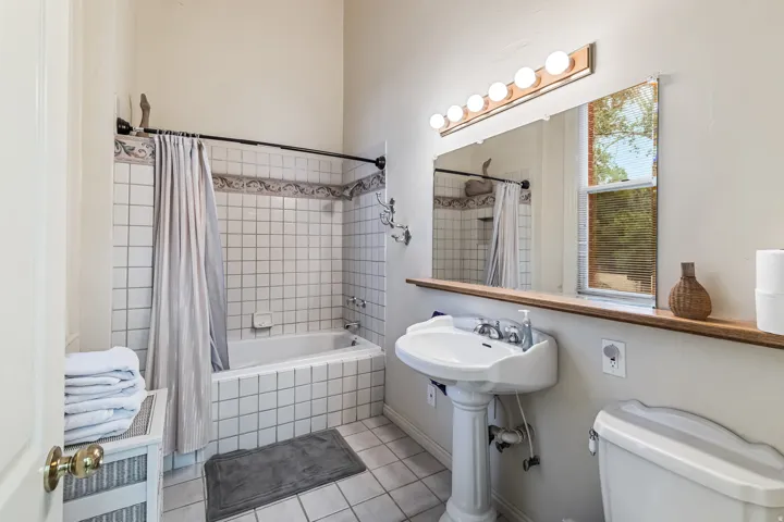 Bathroom featuring tiled shower / bath and light tile patterned floors