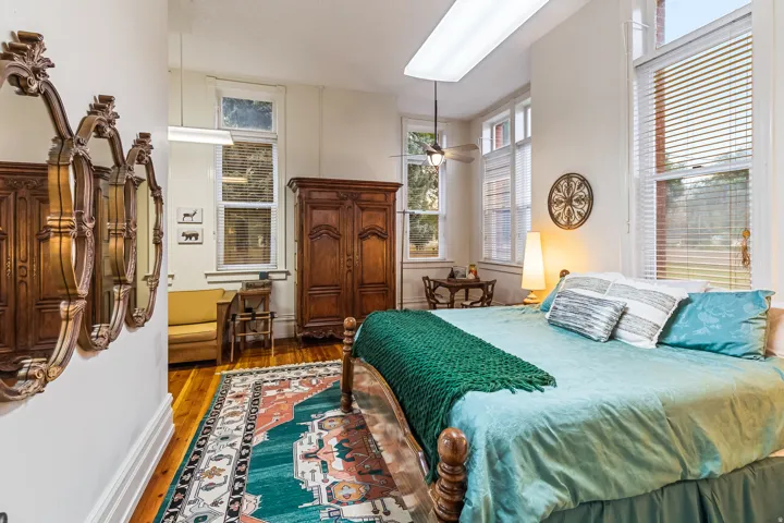 Bedroom featuring dark wood finished floors and baseboards