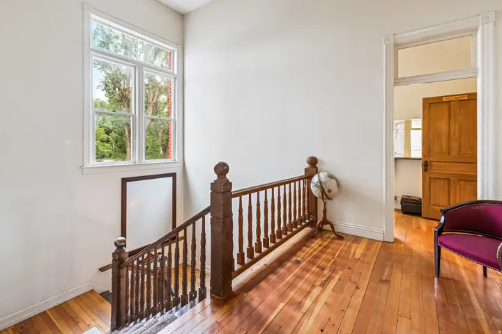 Stairway featuring wood-type flooring and baseboards