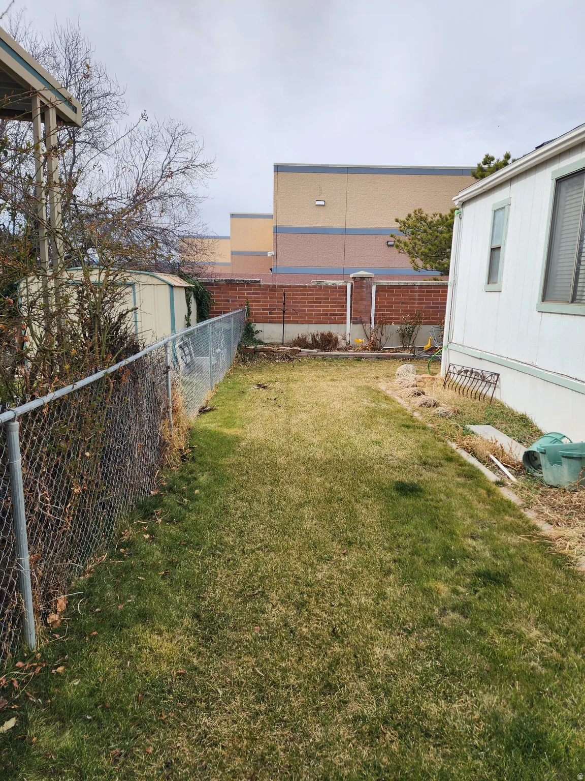 Fenced backyard with a shed