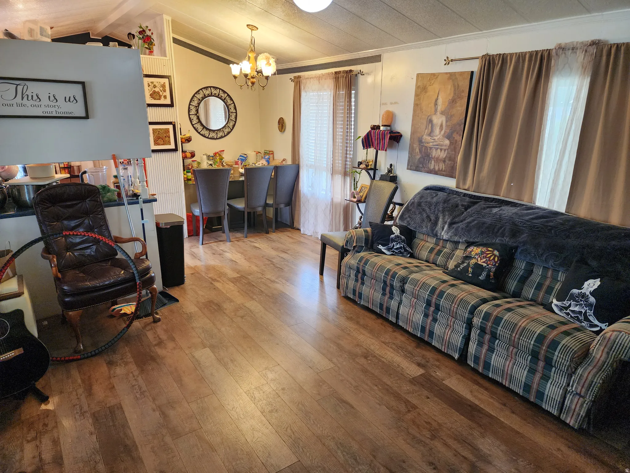 Living area featuring wood-type flooring and a chandelier