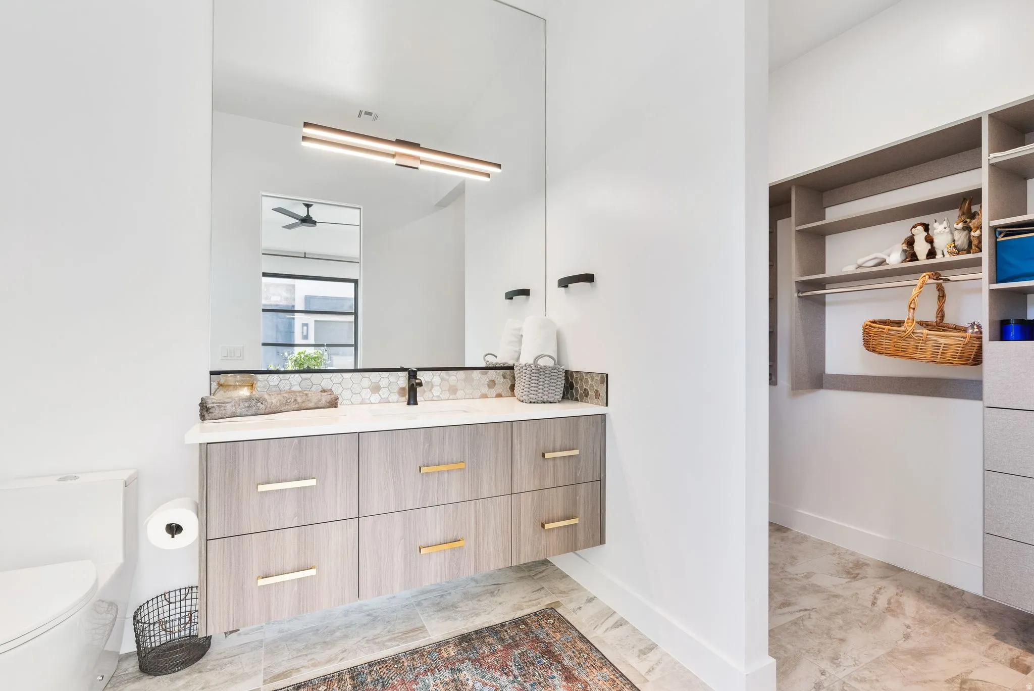 Bathroom featuring vanity and a spacious closet