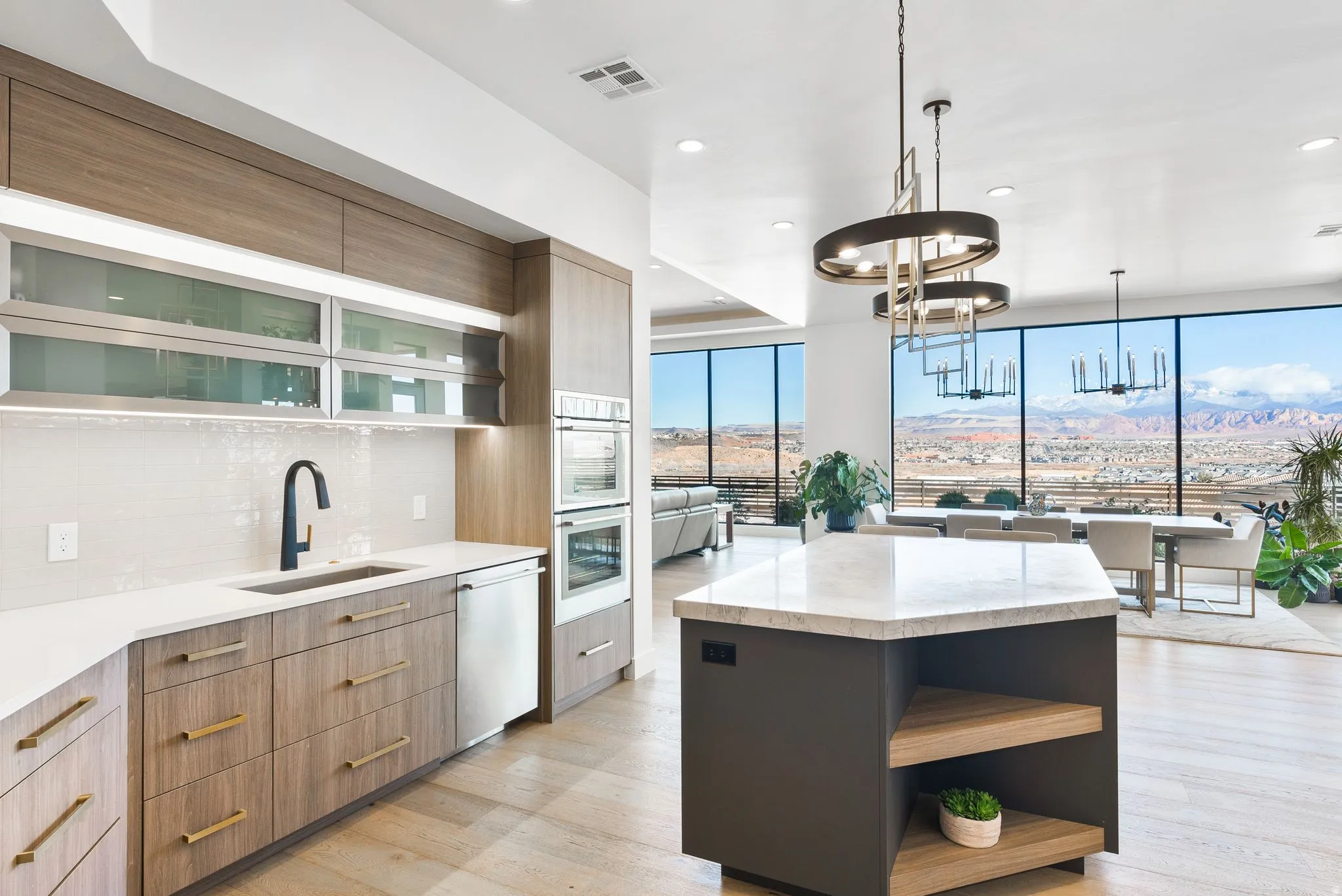 Dual tone kitchen featuring a center island, two tone cabinetry, open shelves, modern cabinets, and light stone counters