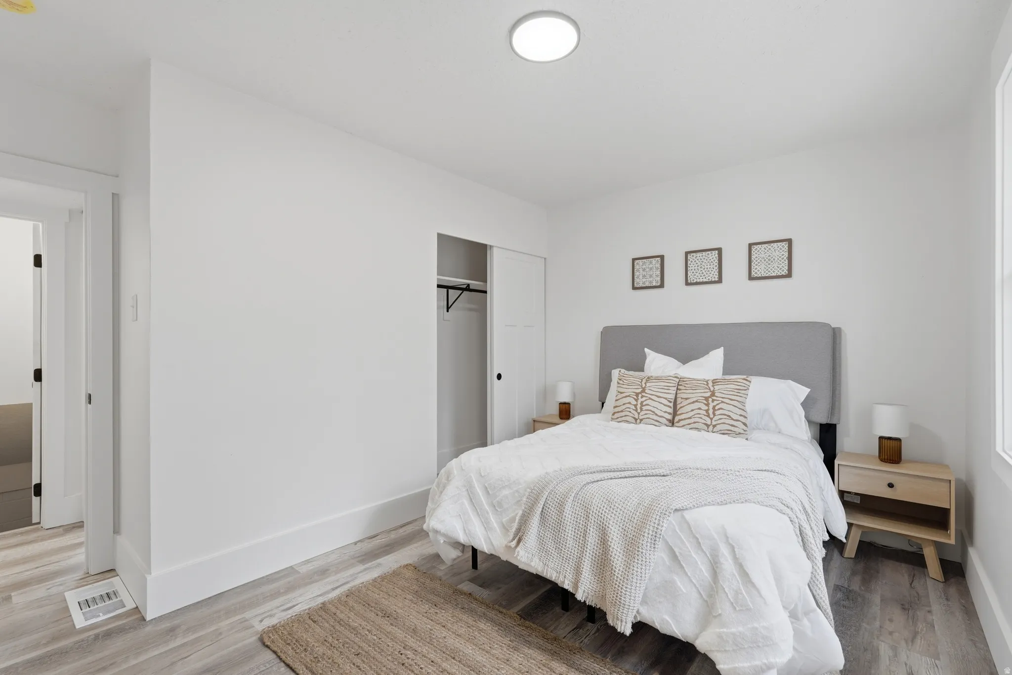 Bedroom with a closet and light wood finished floors