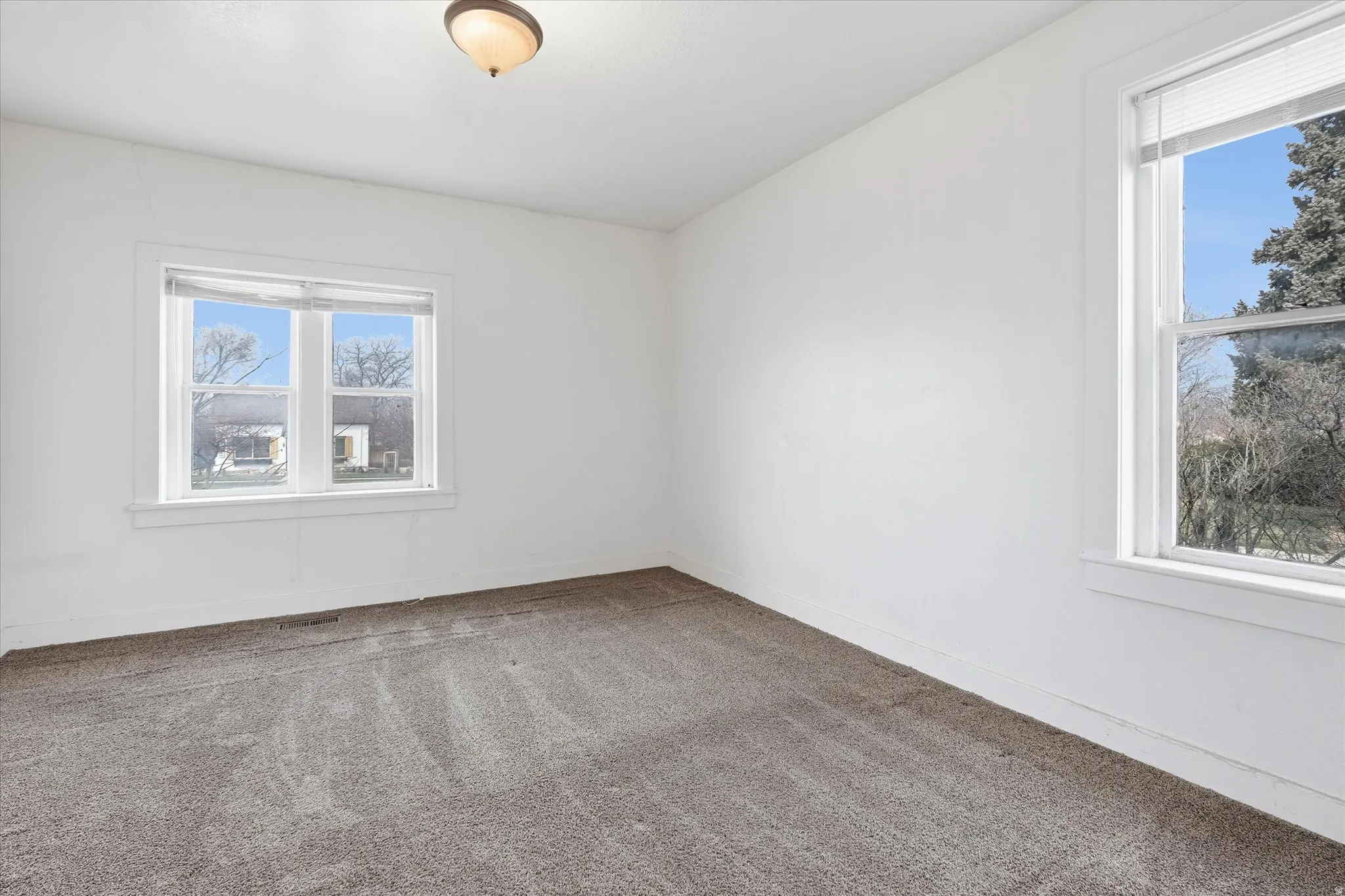 Spare room with carpet and baseboards