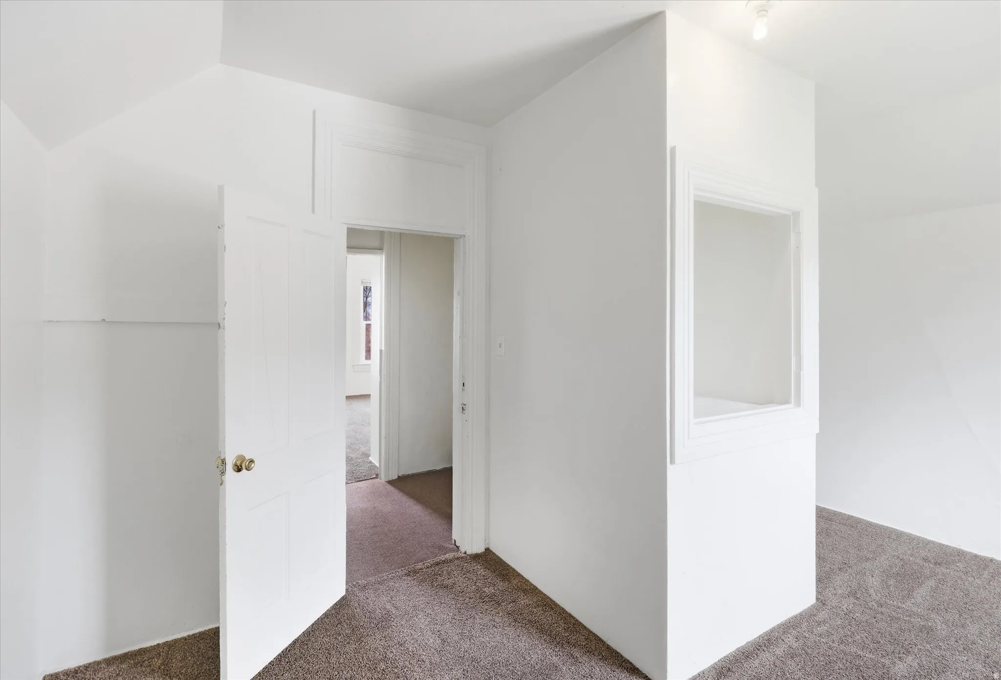 Additional living space with carpet flooring and lofted ceiling