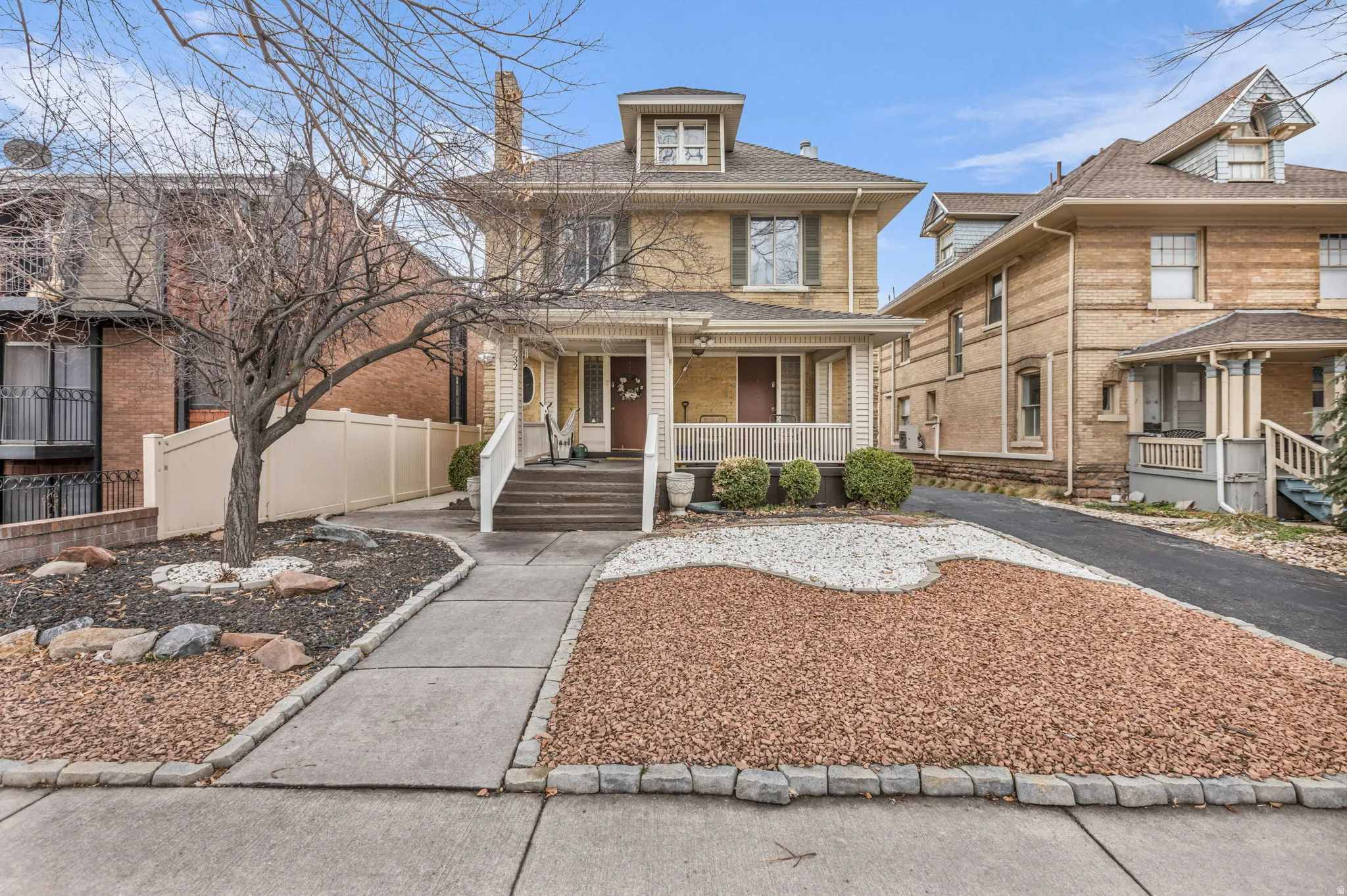 Traditional style home with covered porch and brick siding