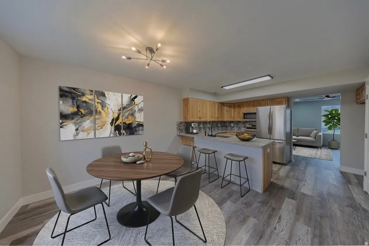 Dining room with dark wood finished floors and baseboards