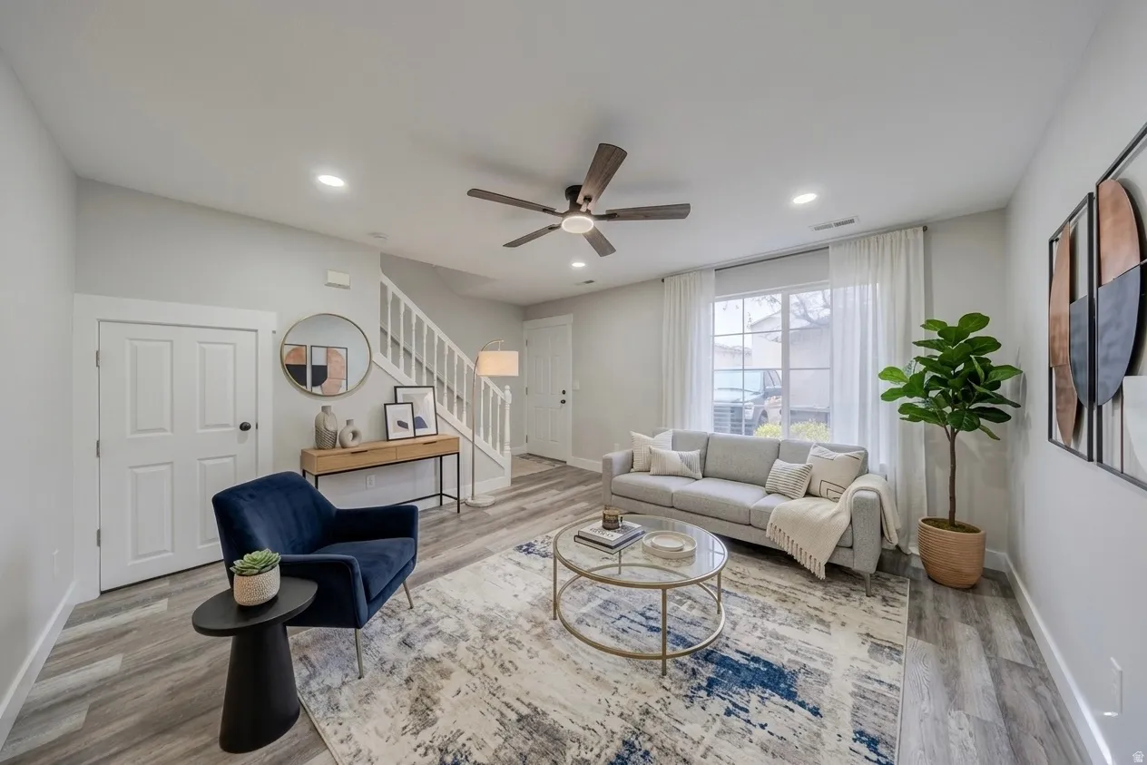Living area with a ceiling fan, light wood-type flooring, and recessed lighting