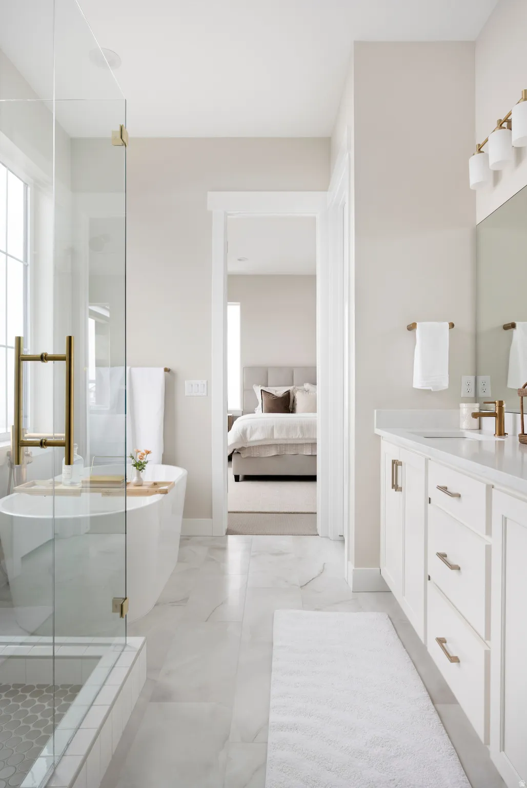 Ensuite bathroom featuring vanity, a stall shower, and a soaking tub