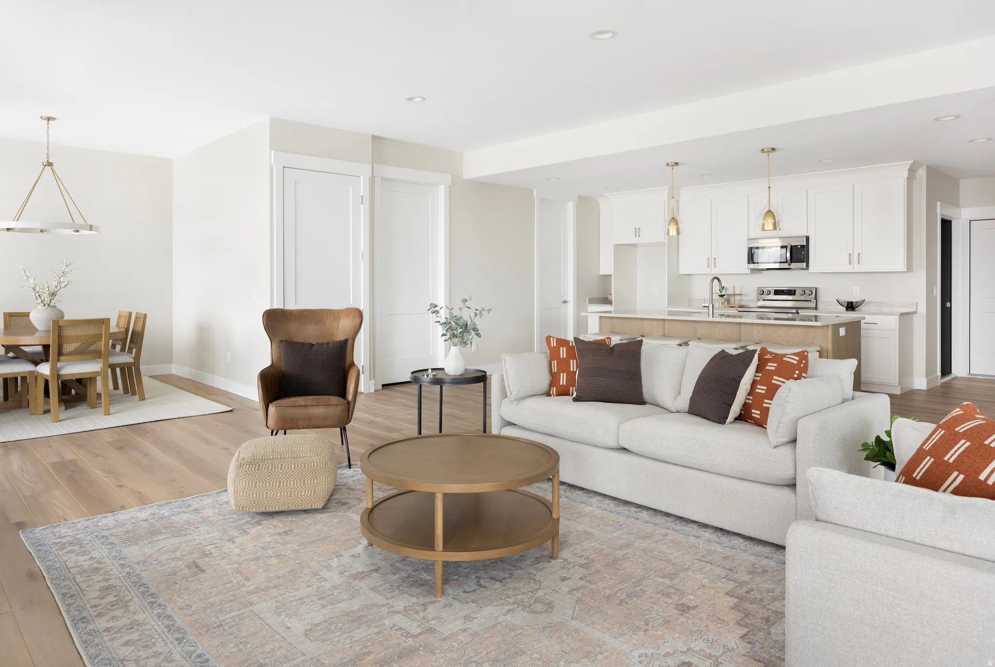 Living area with light wood finished floors and a chandelier