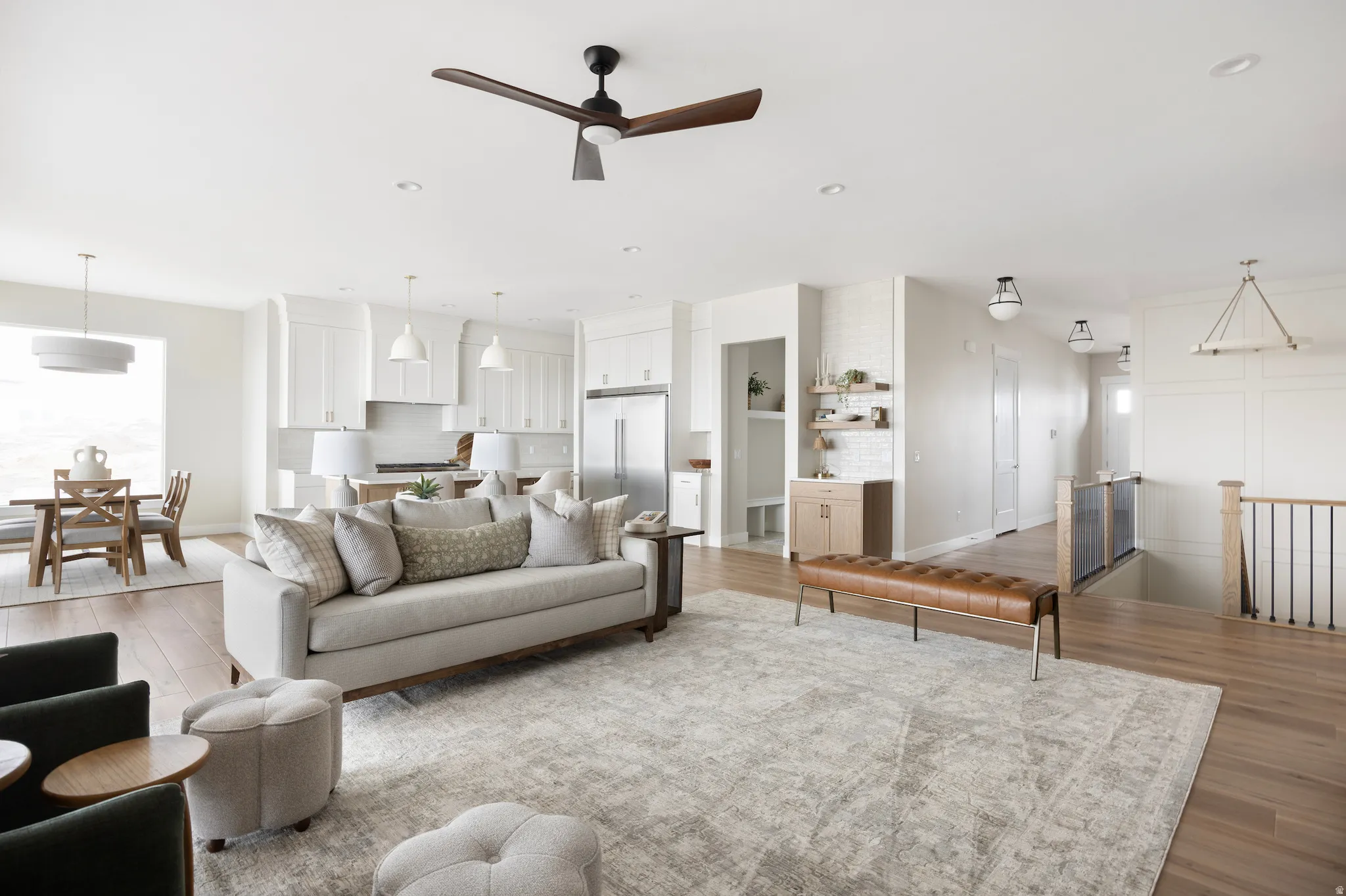 Living room featuring a ceiling fan, light wood-style floors, and recessed lighting