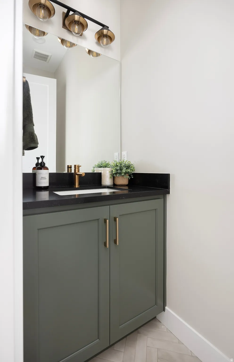 Bathroom with vanity and baseboards