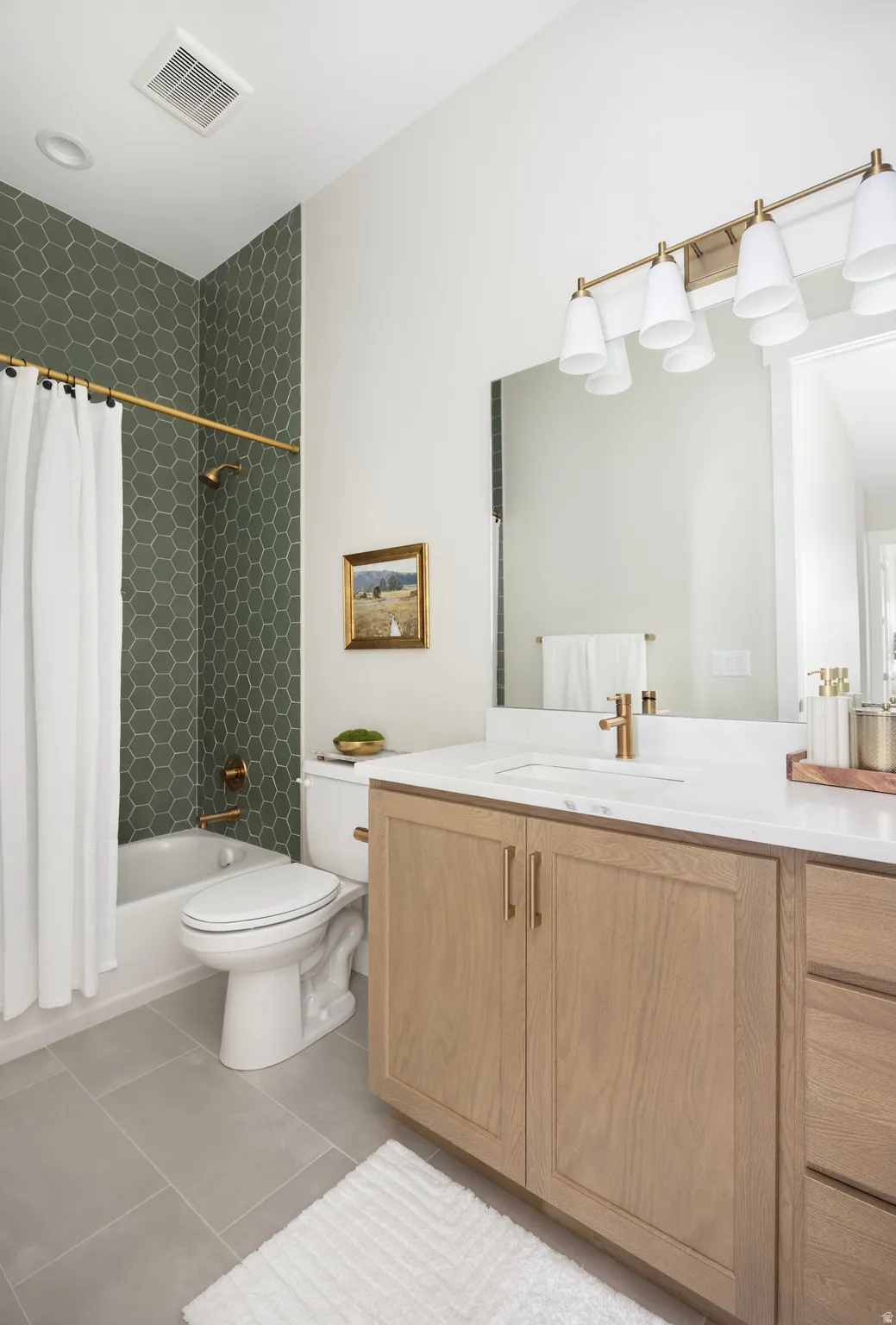 Full bathroom with vanity, shower / bath combination with curtain, and light tile patterned flooring