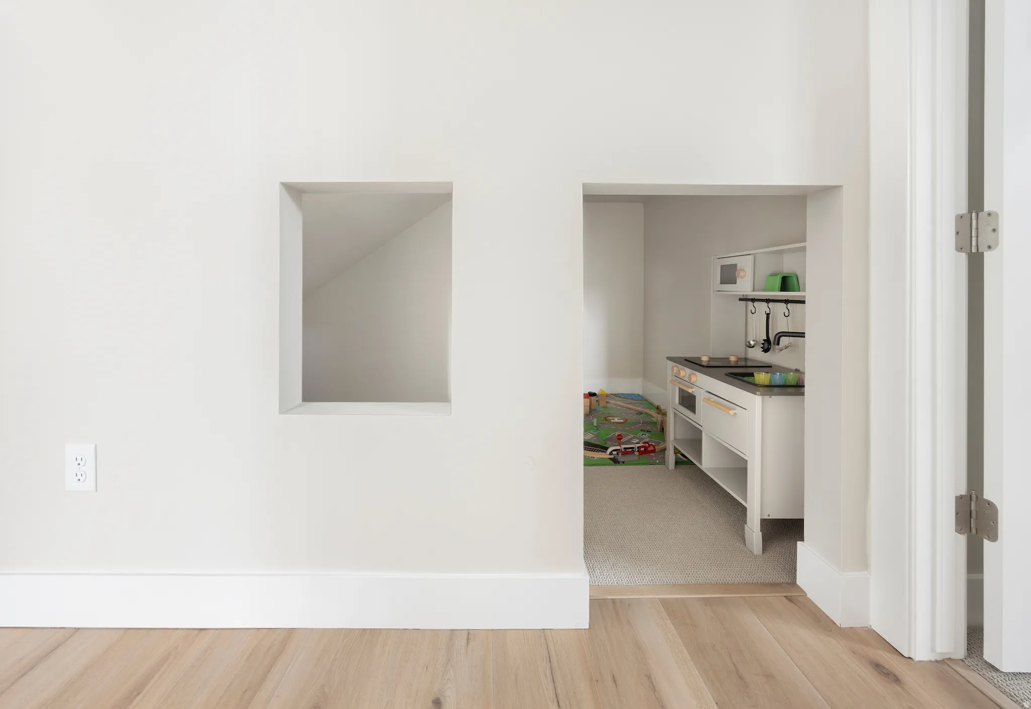 Corridor featuring light wood-type flooring and baseboards