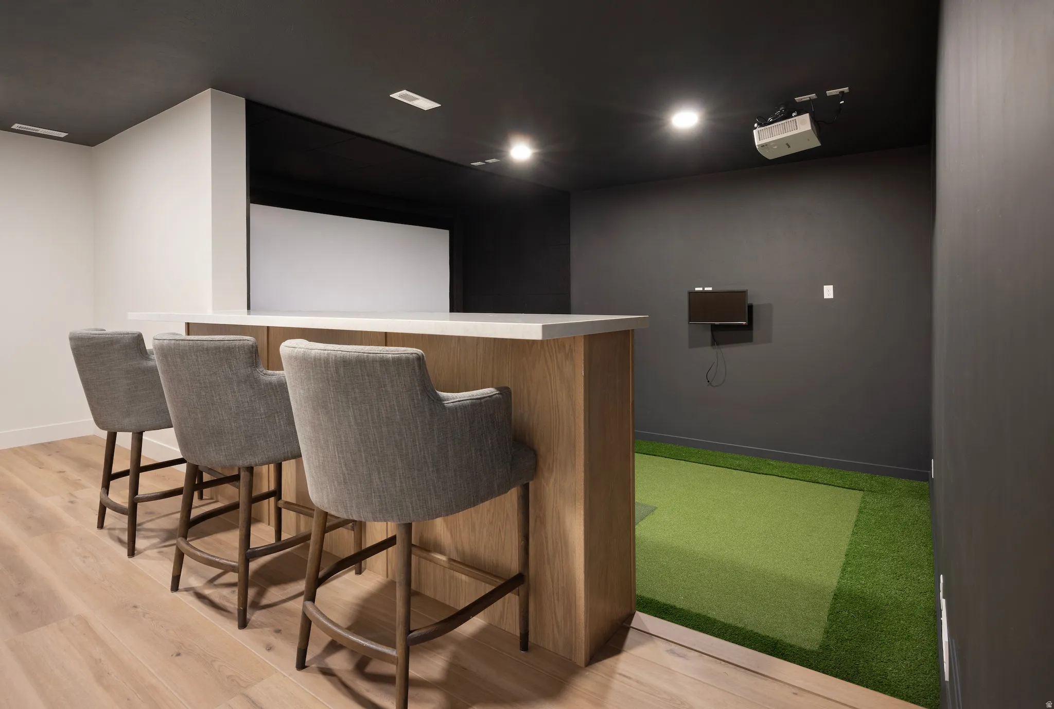 Home theater featuring light wood-style flooring